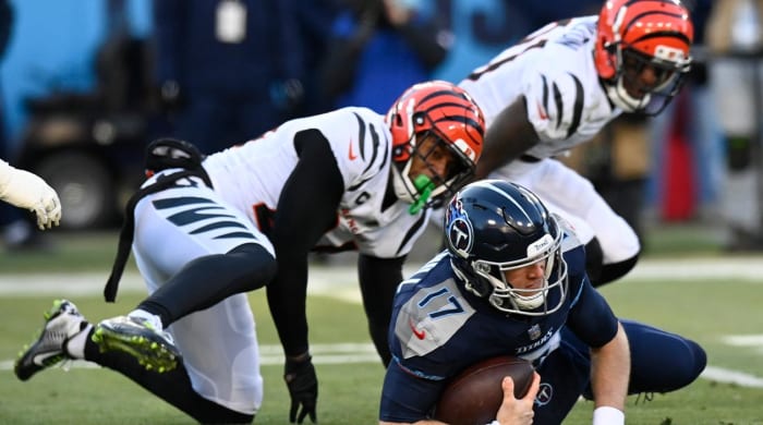 Cincinnati Bengals cornerback Mike Hilton (21) and Cincinnati Bengals safety Vonn Bell (24) sack Tennessee Titans quarterback Ryan Tannehill (17) during the first half of an NFL divisional round playoff football game, Saturday, Jan. 22, 2022, in Nashville, Tenn.